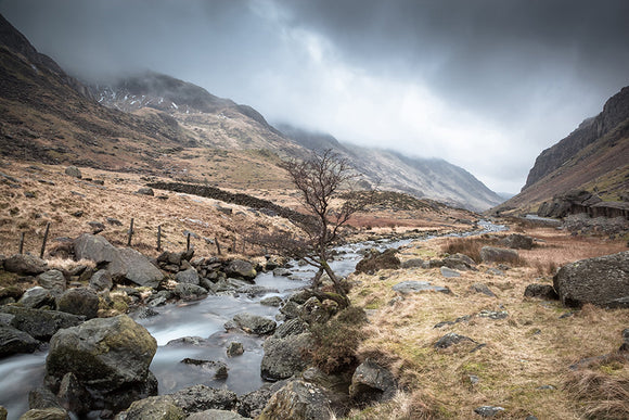 Afon Nant Peris, Snowdonia - North Wales. The river that runs along the pass from Pen y Pass towards Llanberis. Dark clouds settle above this moody looking landscape. Smart Imaging & Framing Landscape Photography