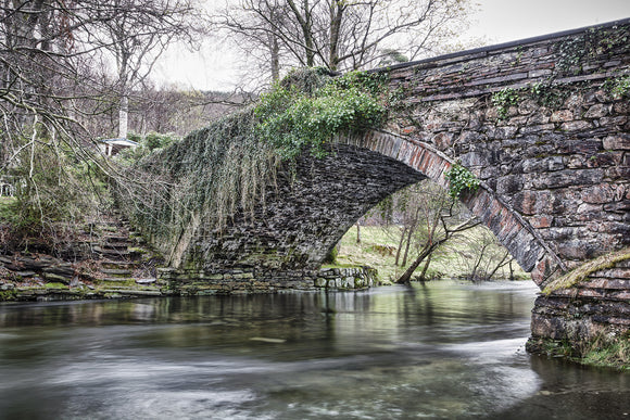 Ogwen Bank Bridge, Bethesda - Snowdonia, North Wales. The stone bridge that spans Afon Ogwen running from the mountains beyond. Smart Imaging & Framing Landscape Photography