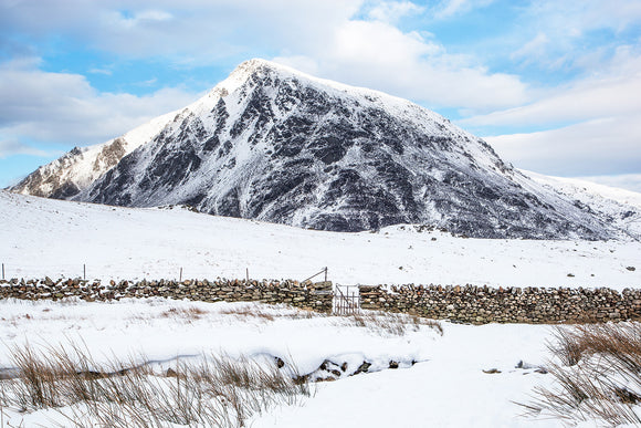 Pen yr Ole Wen Winter, Snowdonia. The snow is thick on the ground in this photograph taken from Cwm Idwal, looking towards the imposing mountain opposite. A crisp day with blue cloudy skies. Smart Imaging & Framing Landscape Photography