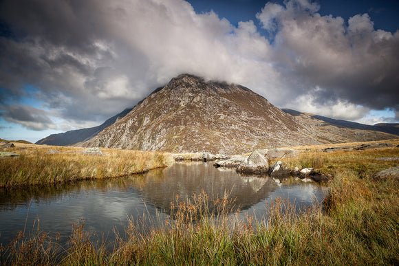 Pen yr Ole Wen, Snowdonia - stands beneath a blue, cloudy sky, reflecting in the waters of Llyn Idwal. A beautiful Welsh Countryside scene