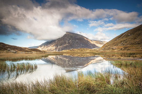 Pen yr Ole Wen Reflections, Snowdonia - North Wales. A vibrant, colourful scene with blue, cloudy sky and the mountain of Pen yr Ole Wen reflecting in the Lake of Llyn Idwal. Smart Imaging & Framing Landscape Photography