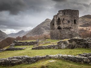 A Castle in the Mountains - Dolbadarn Castle stands below some stormy looking clouds on the hillside above llyn padarn in llanberis, Snowdonia National Park