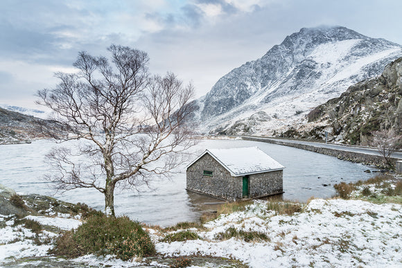 Llyn Ogwen, A Winter's Day - Snowdonia, North Wales. A light dusting of snow covers the imposing mountain of Tryfan, next to Llyn Ogwen. A chilly looking lakeside scene. Smart Imaging & Framing Landscape Photography