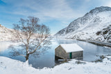 Snowfall at Llyn Ogwen - A crisp, Winter's day in Snowdonia National Park. White snow lays all around while the blue sky above reflects on the frozen surface of Llyn Ogwen